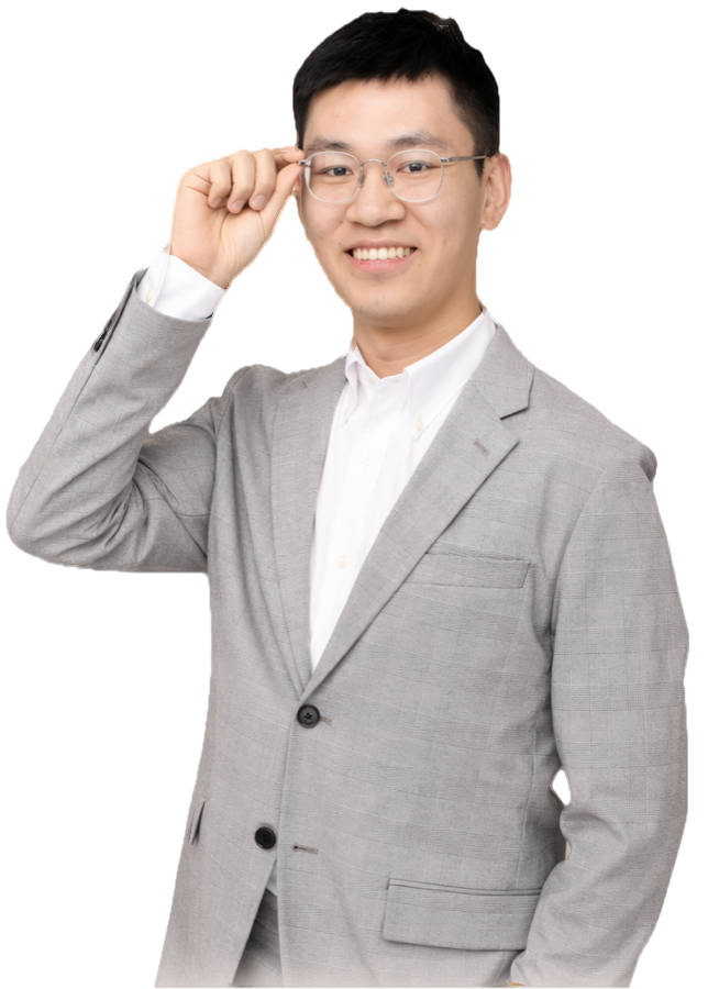 Tom, MatchUs UK Partner, in a grey suit adjusting his glasses, smiling